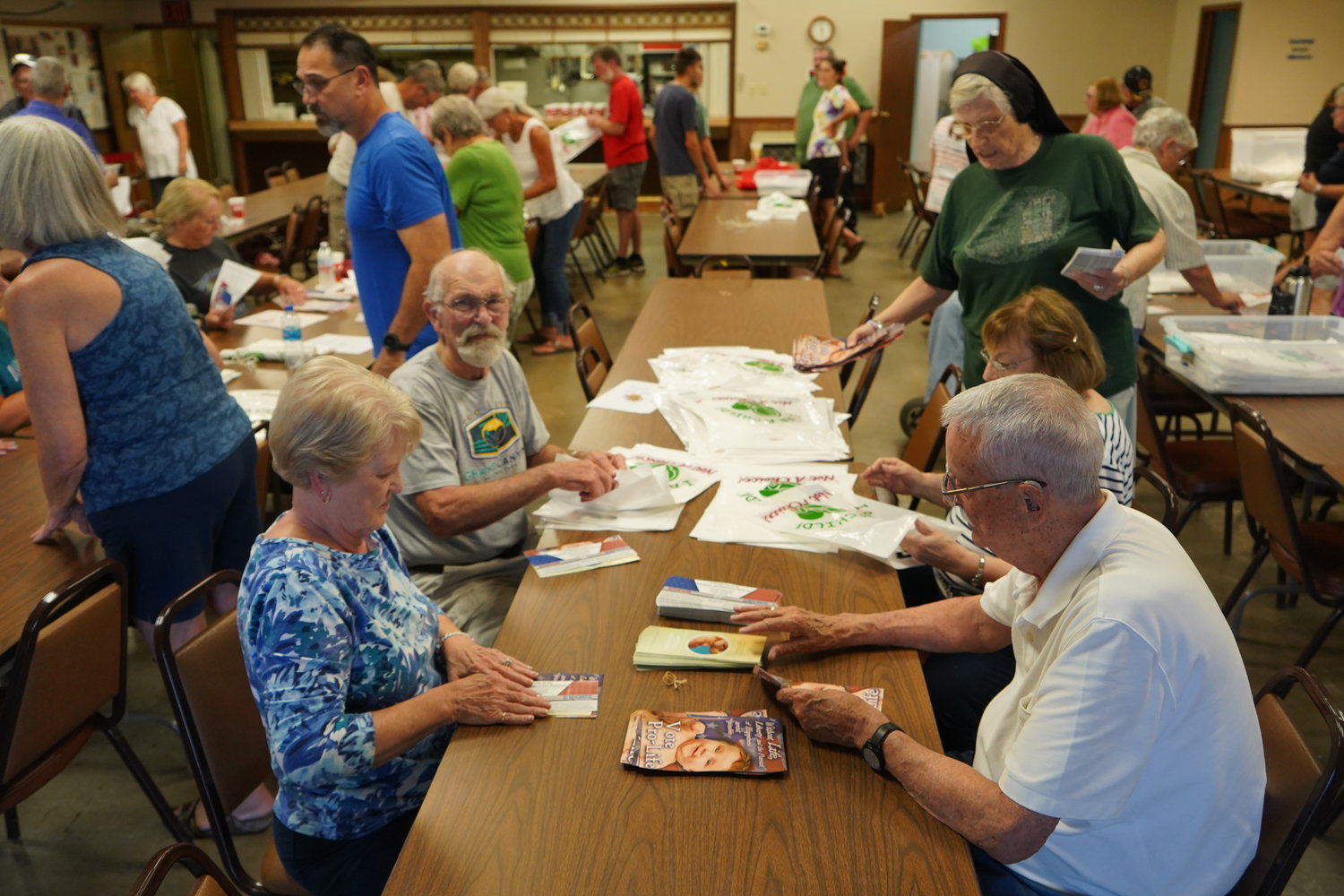 Volunteers gather in Knights of Columbus Council 831’s hall in Sedalia on Aug. 3, to fill 3,000 bags with informational materials for the 48th annual Right to Life booth at the Missouri State Fair in Sedalia.